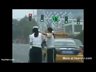 chinese policemen fighting on the road